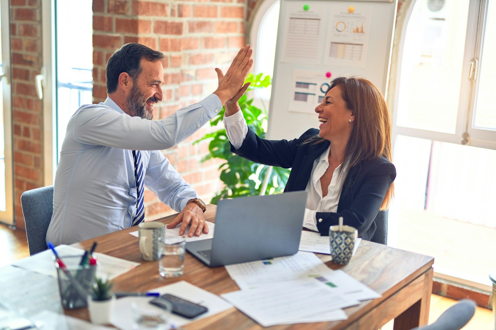 Colleagues sharing a high five after a successful meeting